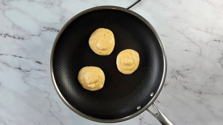 Pancake batter mounds in pan