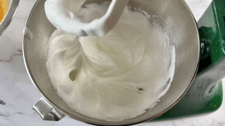 Egg whites beaten to stiff peaks in stand mixer bowl
