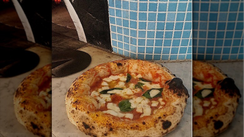 Wood-fired pizza on counter
