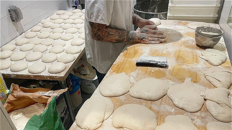 Person kneading raw dough