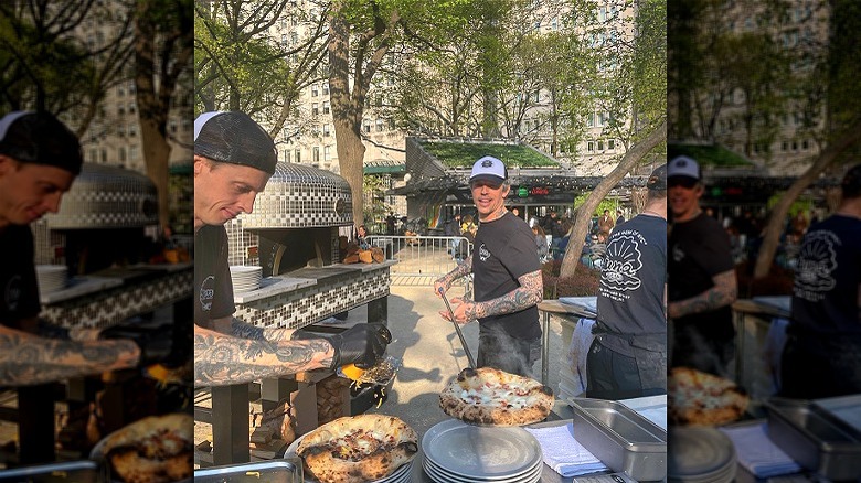 Chefs with wood-fired pizzas