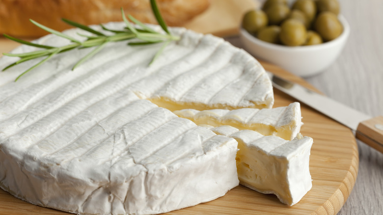 Brie cheese round on board