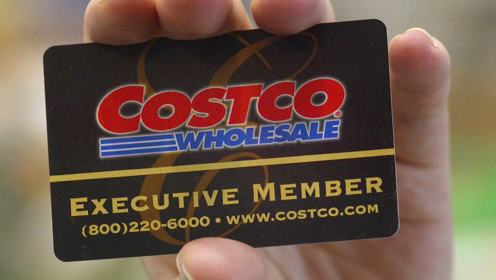 Hand holding a Costco membership card