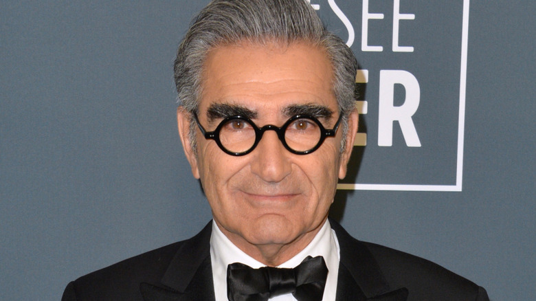 Eugene Levy smiling for cameras at publicity event