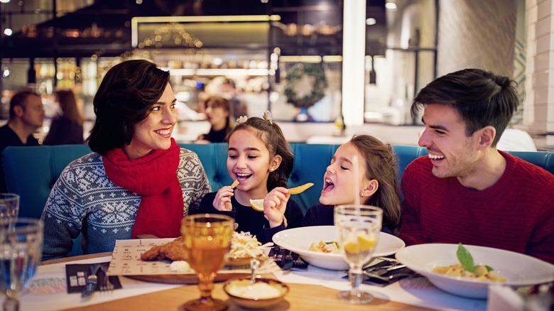 Family dining in crowded restaurant