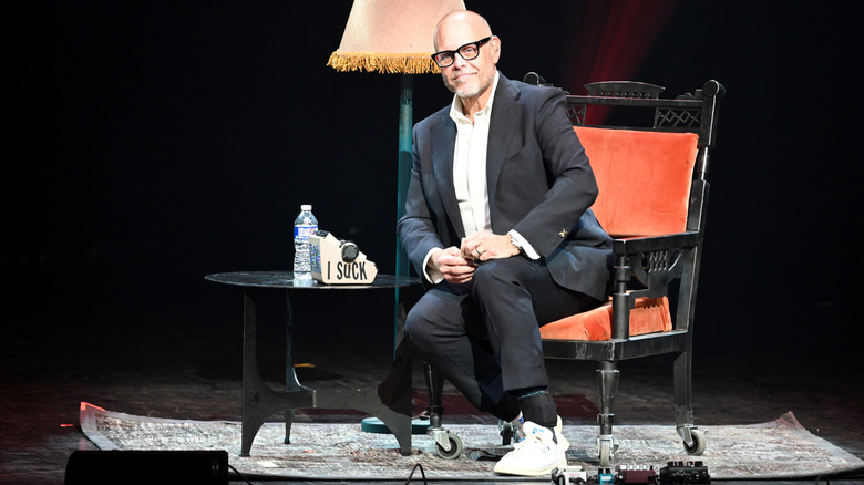 Alton Brown sitting on stage