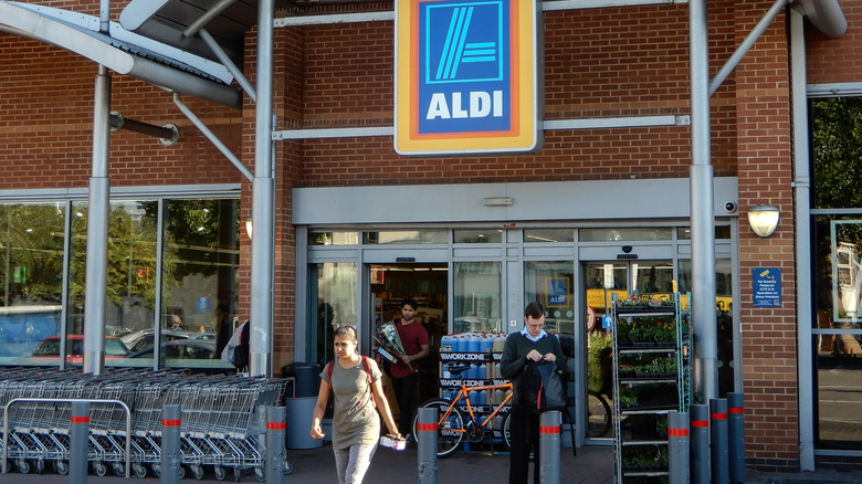 Customers leave an Aldi store