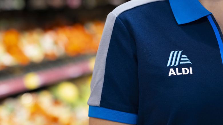 Aldi logo on a polo shirt worn by an employee
