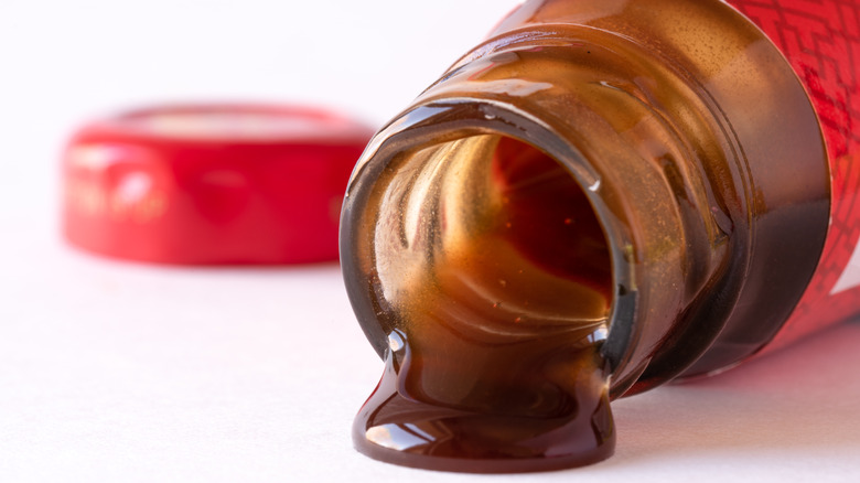 Oyster sauce dripping from bottle
