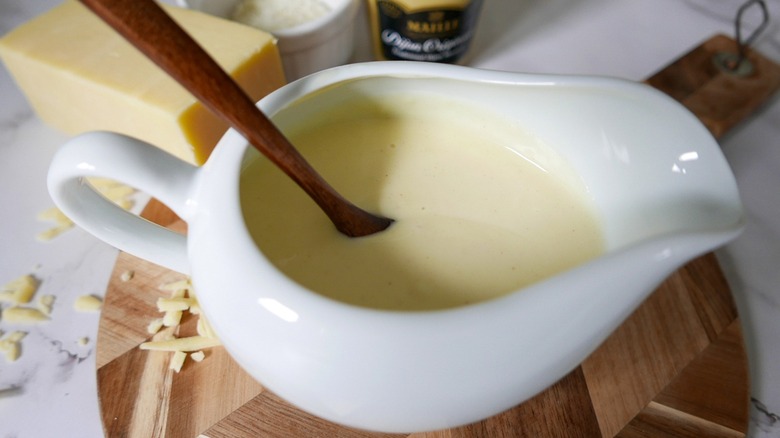 cheese sauce with wooden spoon