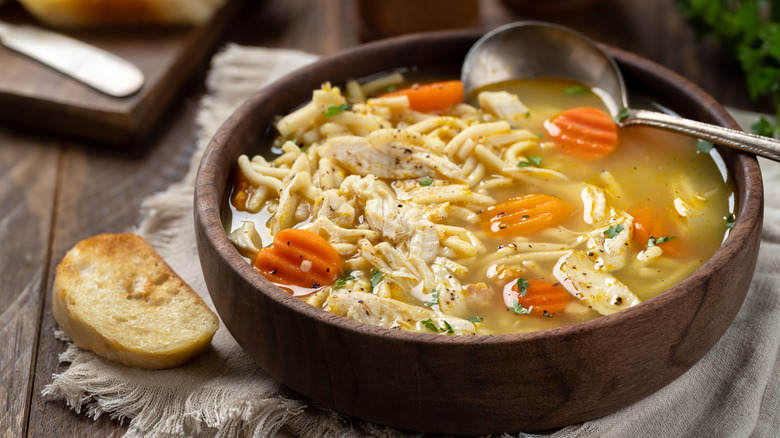 Bowl of chicken noodle soup with spoon