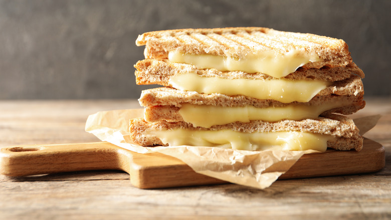 Stacked grilled cheese on wooden board