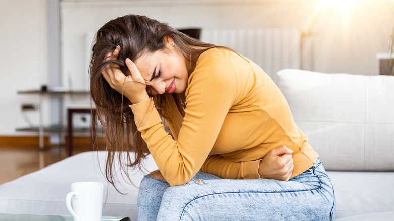 Woman sick and holding her stomach
