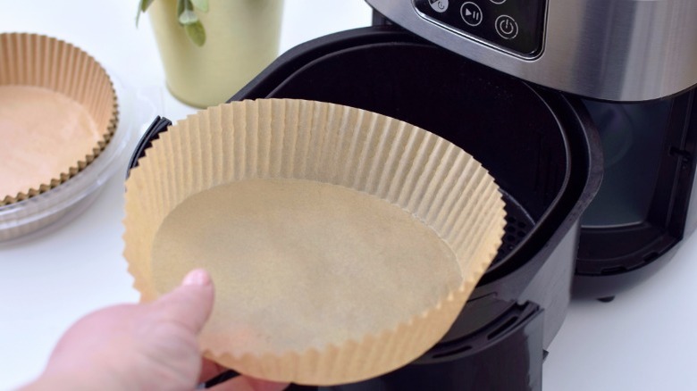 Air fryer liner in a basket.
