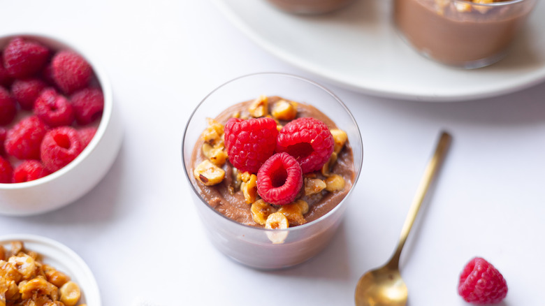 chocolate mousse in cup topped with raspberries 