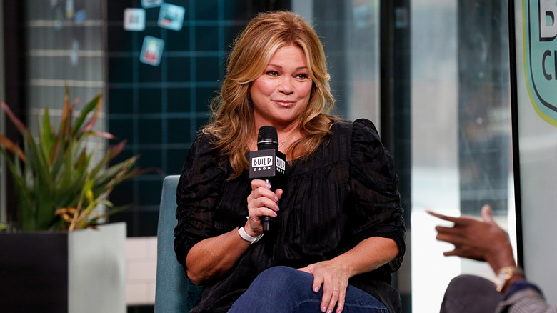 valerie bertinelli giving interview while holding microphone