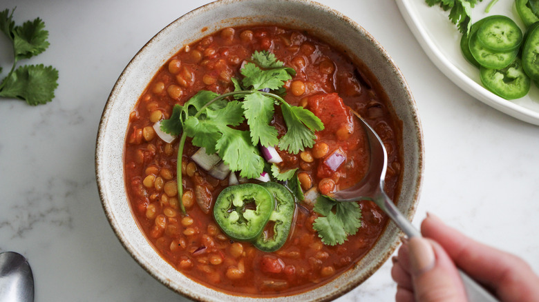 bowl of chili with fingers