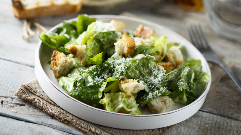 Caesar salad in a white bowl