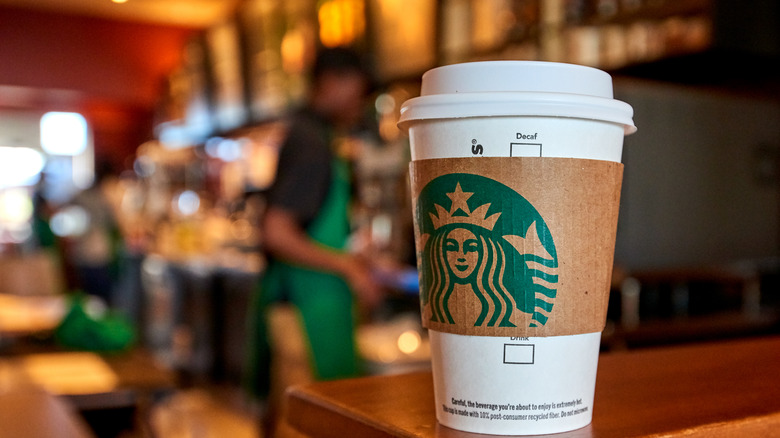 Hot Starbucks cup on hand off shelf