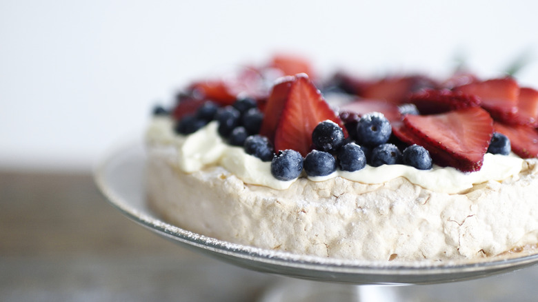 meringue pie with blueberries and slices of strawberries on top