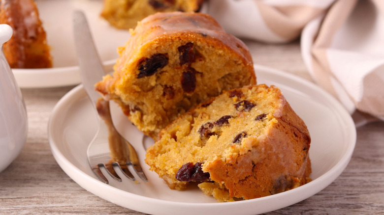 A serving of Irish whiskey cake on a plate with a fork