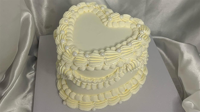 Heart shaped cake decorated with piping and pearls