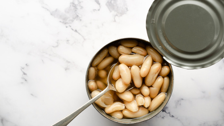 open can of beans with spoon inside