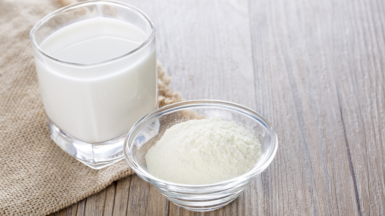 bowl of powdered milk next to glass of milk