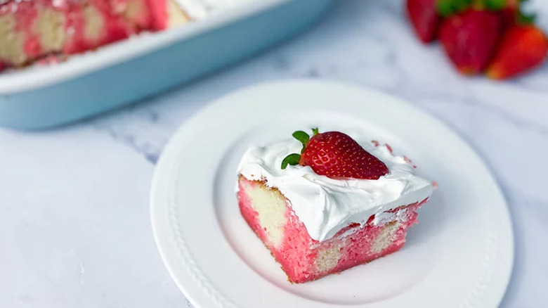 Jello poke cake served with strawberry on top