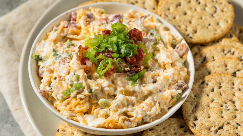A bowl of million-dollar dip next to crackers