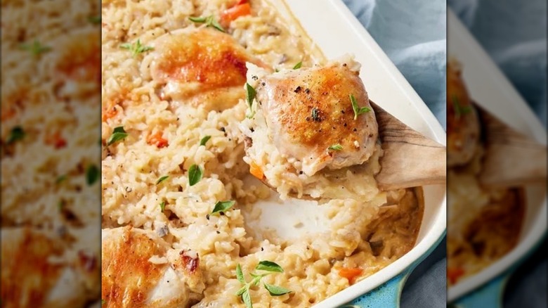 No peek chicken casserole being scooped out of a dish with a wooden spoon