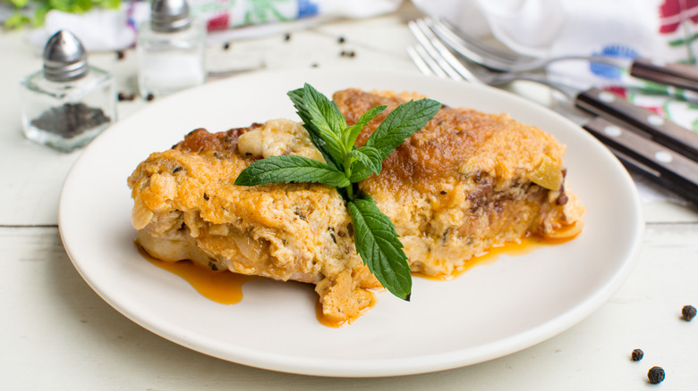 Smothered chicken garnished with fresh herbs