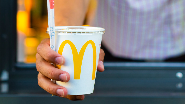 person holding McDonalds drink