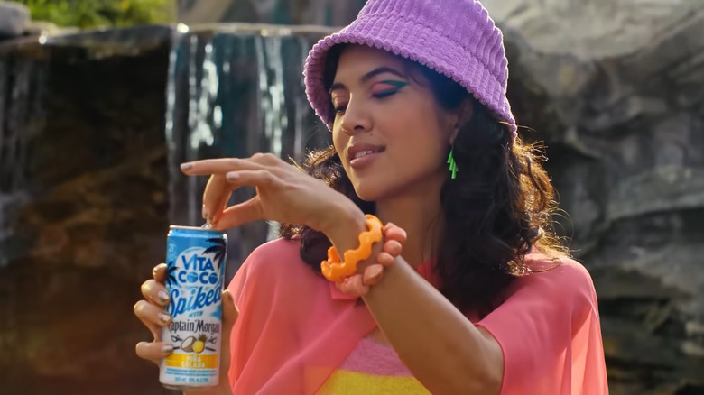 Woman opens Vita Coco can