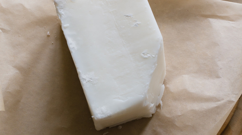 a block of beef tallow on wax paper