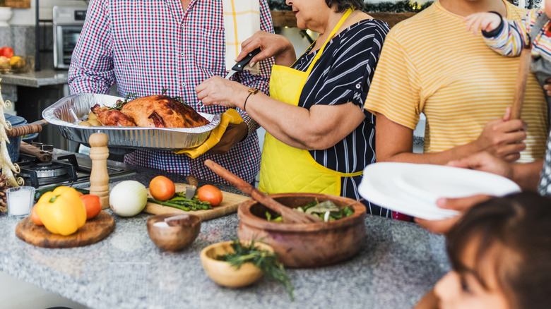 Busy kitchen full of cooks and guests