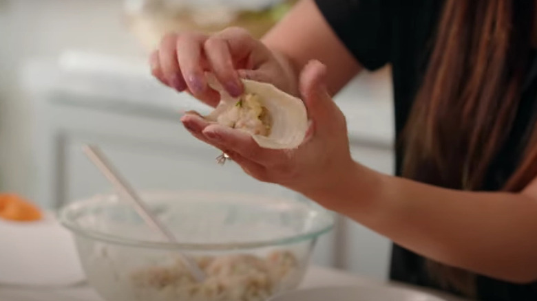 Folding dumplings with a diamond ring on