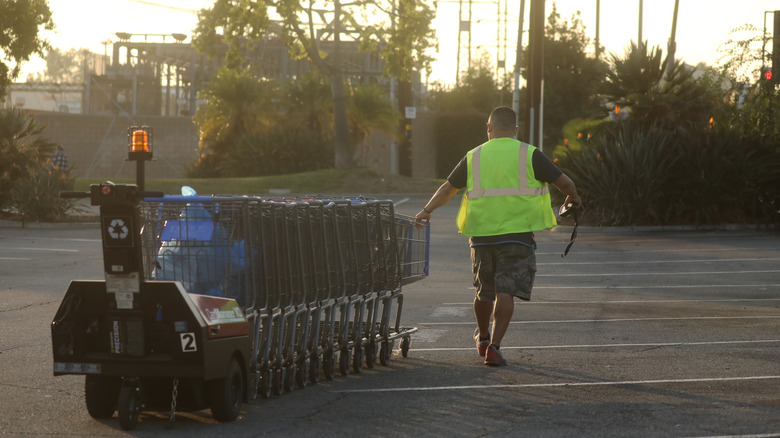 Walmart worker pulling carts