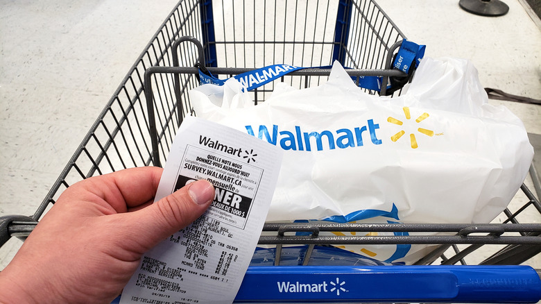 Walmart customer with receipt and cart