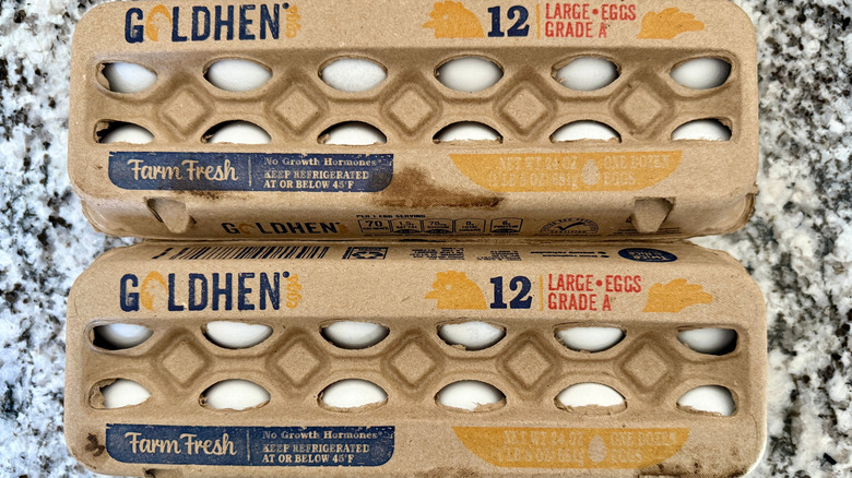 Cardboard Goldhen egg cartons from Aldi on stone countertop.