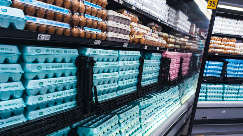 Blue cartons of Great Value eggs displayed on Walmart shelves.