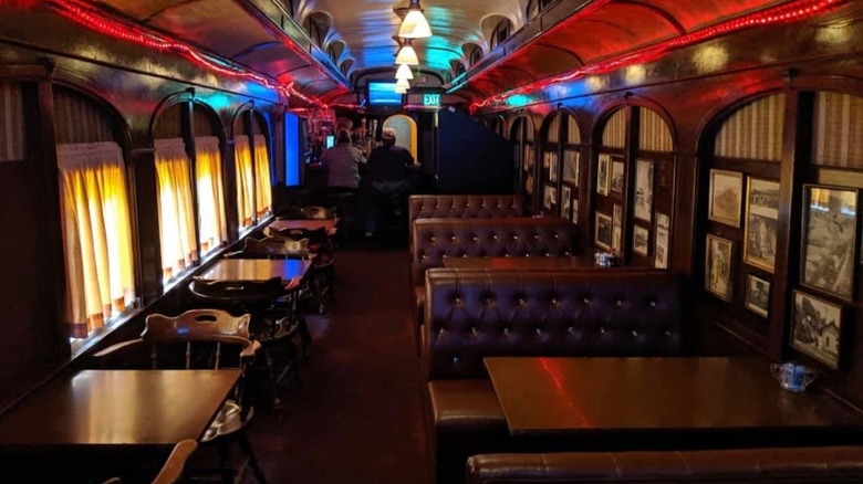 interior of Orient Express, Seattle with wooden paneling and old photos on wall