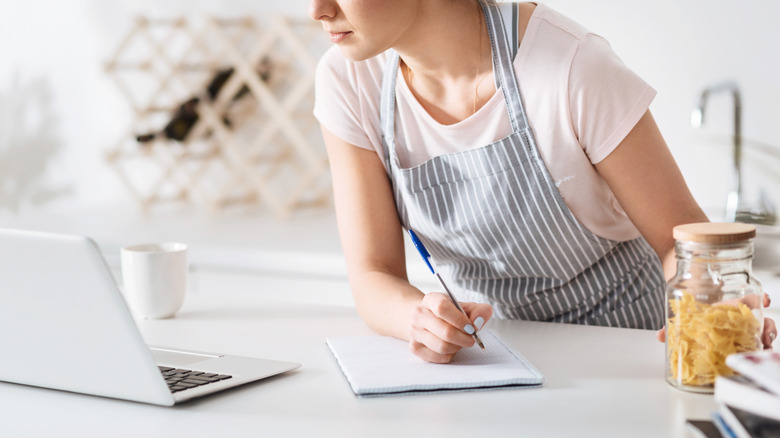 Recipe tester taking notes