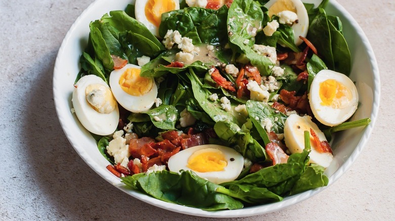 A warm spinach salad served in a bowl