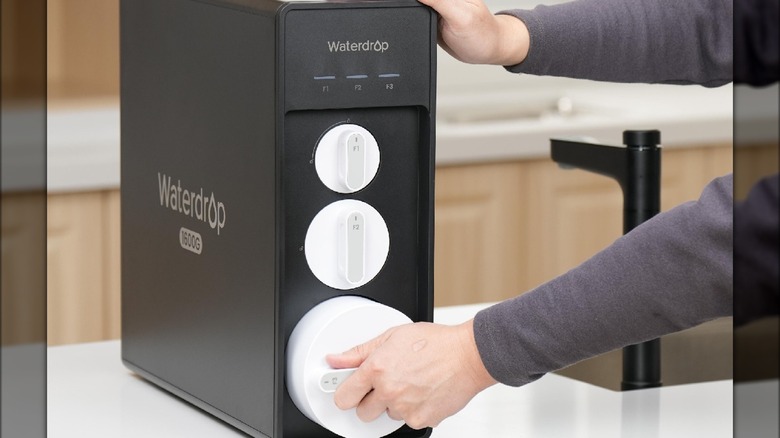 Person changing water filter