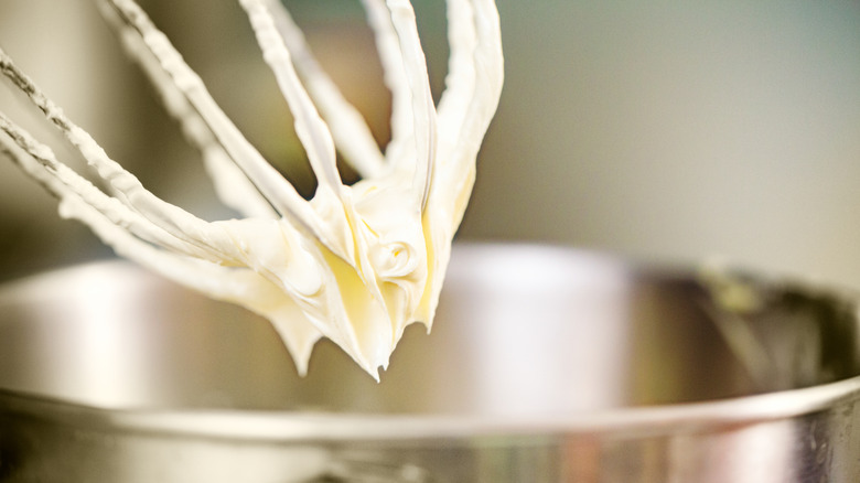Frosting being whipped in an electric mixer