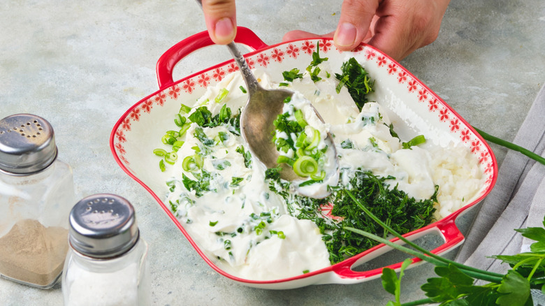 Mixing herbs with cottage cheese