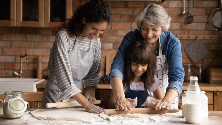daughter, mother, and grandma making pie dough