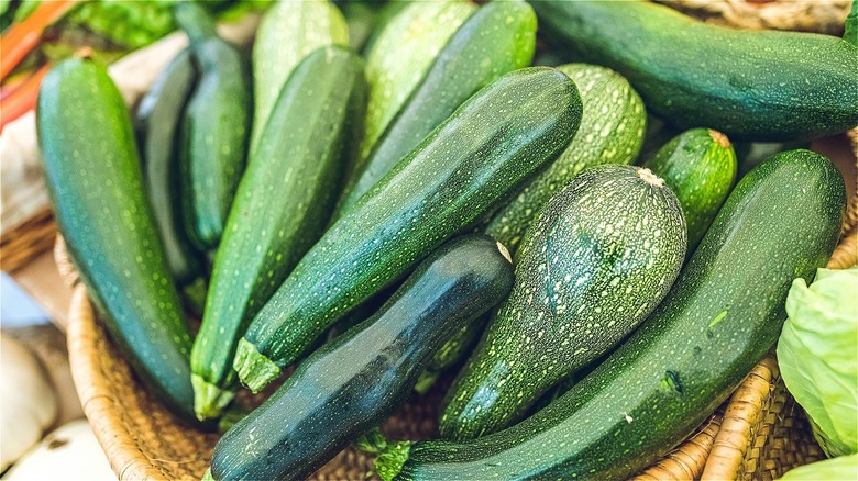 green zucchini in a woven basket