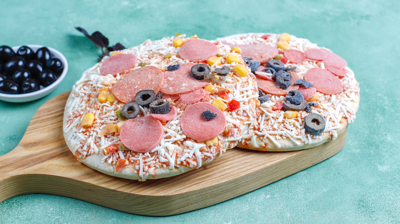 frozen pizza on a board